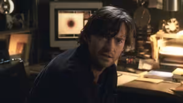 Tom Creo (Hugh Jackman) turns from his desk in a crowded laboratory