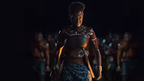 Nanisca (Viola Davis) strides forward with Agojie warriors behind her in darkness