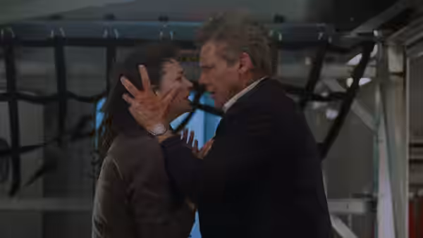 James Marshall (Harrison Ford) holds Grace (Wendy Crewson) by the face inside the aircraft