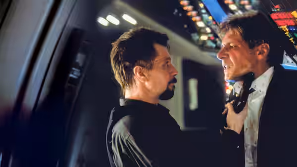 Ivan Korshunov (Gary Oldman) grips James Marshall (Harrison Ford) by the collar in the aircraft cockpit