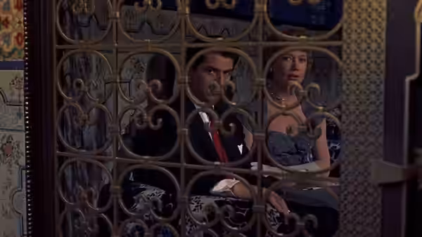 Ben McKenna (James Stewart) and Jo McKenna (Doris Day) peer through an ornate metal grille