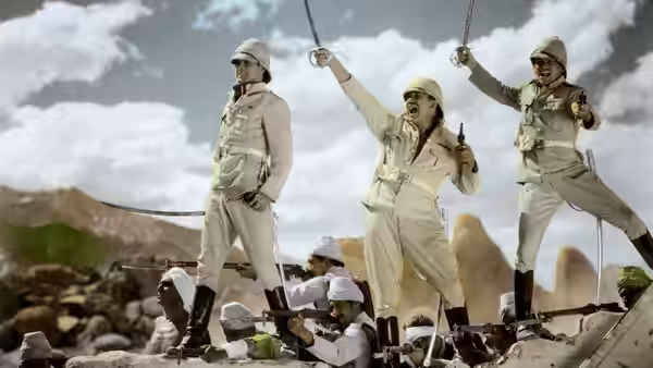 Three uniformed soldiers stand above a crowd, raising their arms against the sky