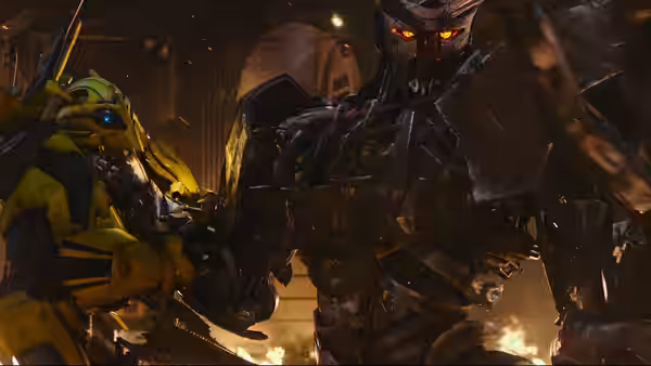 Yellow robot facing larger dark robot inside burning industrial interior at night