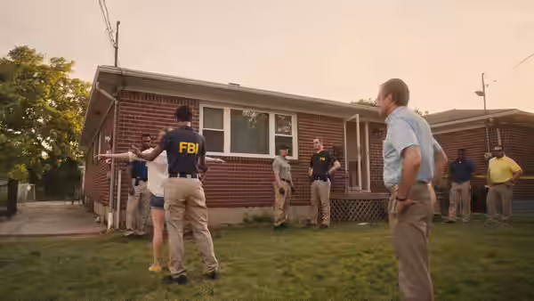 Reality Winner (Sydney Sweeney) outside her home as FBI agents conduct a search