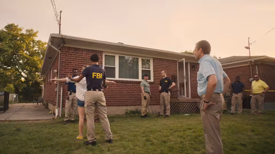 Reality Winner (Sydney Sweeney) outside her home as FBI agents conduct a search
