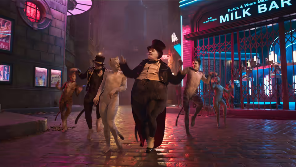 Bustopher Jones leads a group of cats dancing outside the Milk Bar at night