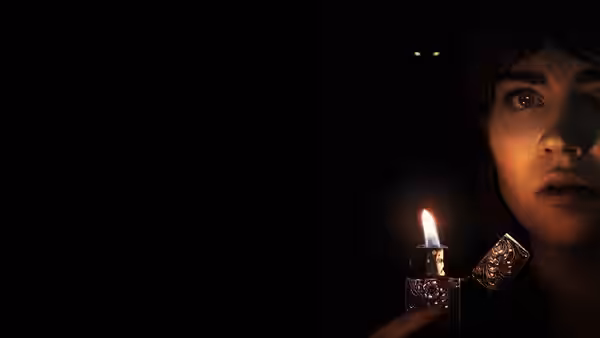 Sadie Harper (Sophie Thatcher) holding a lit lighter close to her face in darkness