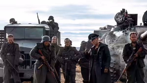 German soldiers gather near military vehicles with one pointing ahead