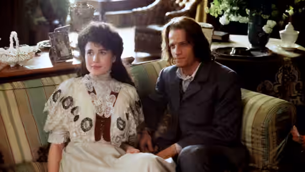 Jane Porter (Andie MacDowell) and John Clayton (Christopher Lambert) sit together on a parlor sofa