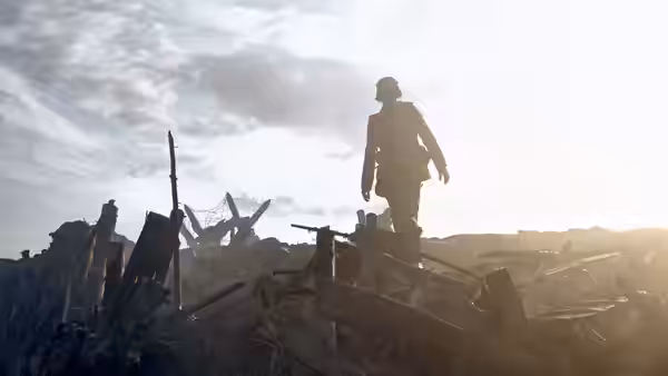 A lone soldier stands on rubble overlooking a devastated landscape at dawn
