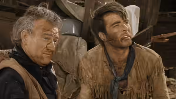 Thomas Dunson (John Wayne) and Matthew Garth (Montgomery Clift) talk inside a wagon
