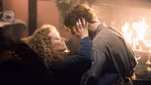 Shannon Christie cradles Joseph Donnelly's face beside a blazing fire