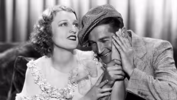 Maurice Courtelin holds Princess Jeanette's hand to his cheek as she looks upward