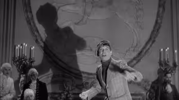 Maurice Courtelin gestures beneath a large ceiling medallion as guests watch