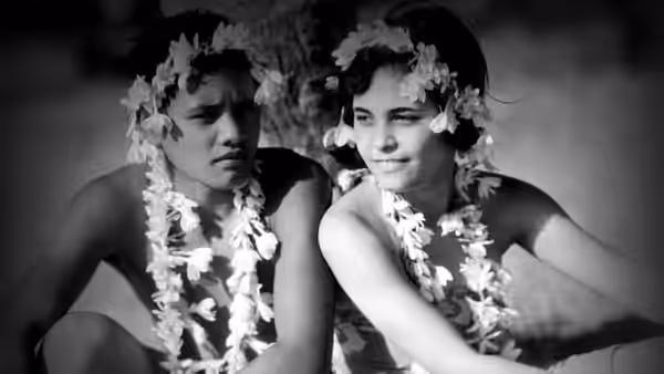 The Boy (Matahi) and The Girl (Anne Chevalier) wear flower garlands and sit together