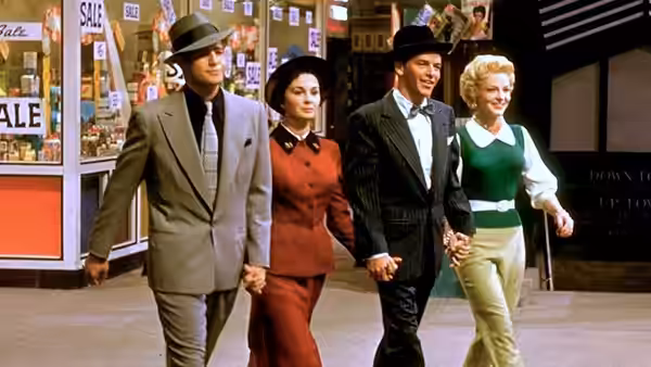 Sky Masterson (Marlon Brando) walks hand in hand with Sarah Brown (Jean Simmons) beside another couple