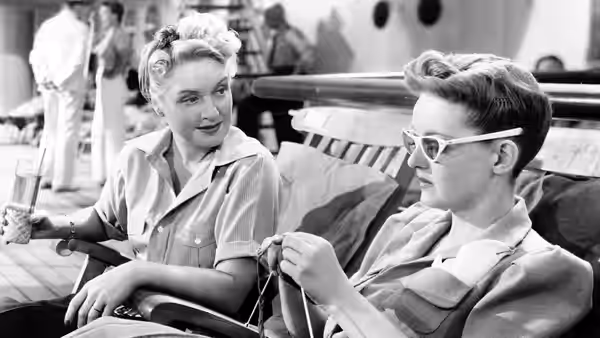 Charlotte (Bette Davis) and Deb (Lee Patrick) relax together on a ship