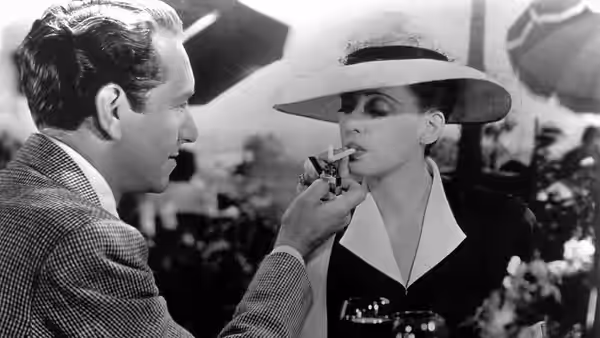 Jerry (Paul Henreid) lights Charlotte’s (Bette Davis) cigarette aboard a ship
