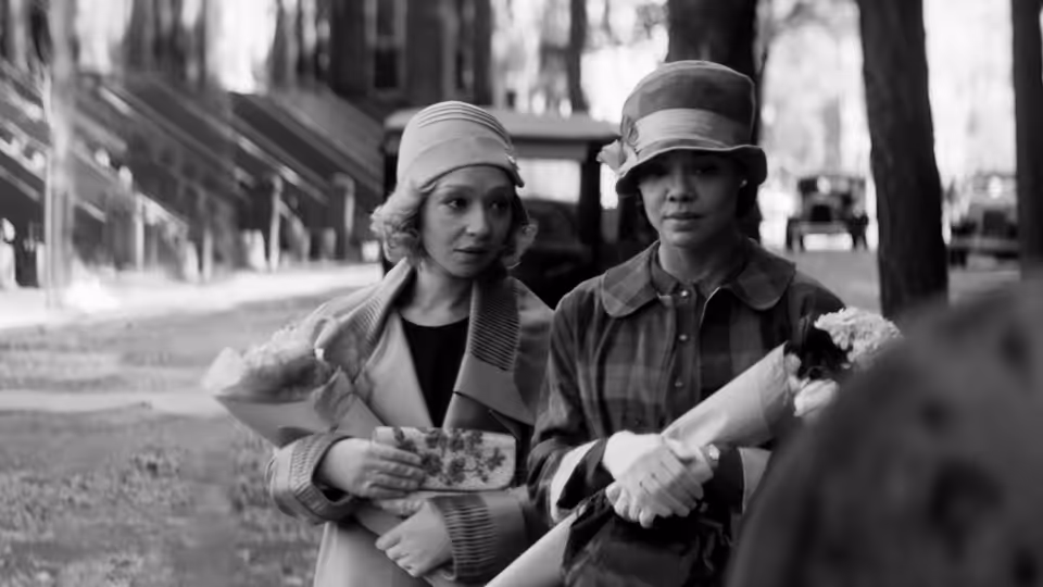 Clare Kendry (Ruth Negga) and Irene Redfield (Tessa Thompson) walk together along a city sidewalk