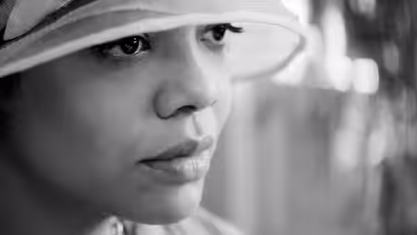Irene Redfield (Tessa Thompson) gazes ahead beneath the brim of her hat