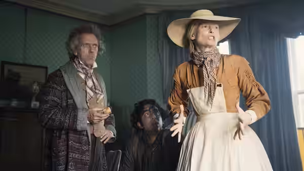 Betsey Trotwood (Tilda Swinton), Mr. Dick (Hugh Laurie), and David Copperfield gather in a sitting room