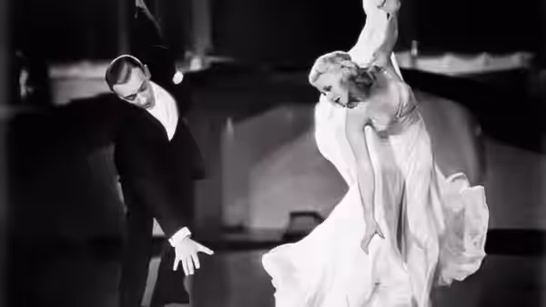Lucky Garnett (Fred Astaire) and Penny Carrol (Ginger Rogers) lean into a dance pose