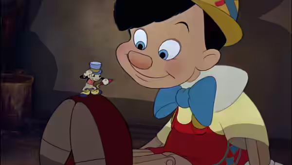 Pinocchio looking down at Jiminy Cricket on his knee