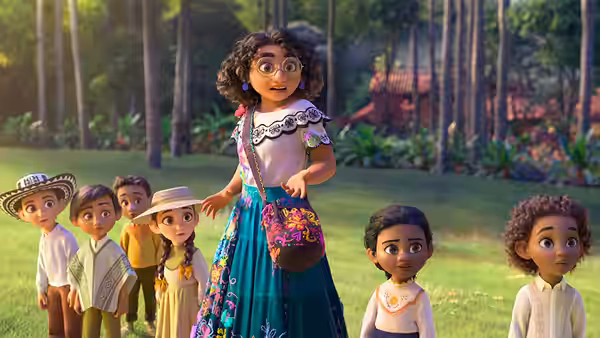 Mirabel addressing children in a grassy forest clearing