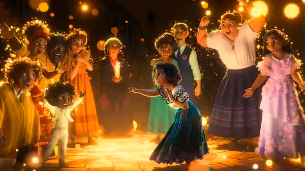 Mirabel dancing with family on a glowing courtyard at night