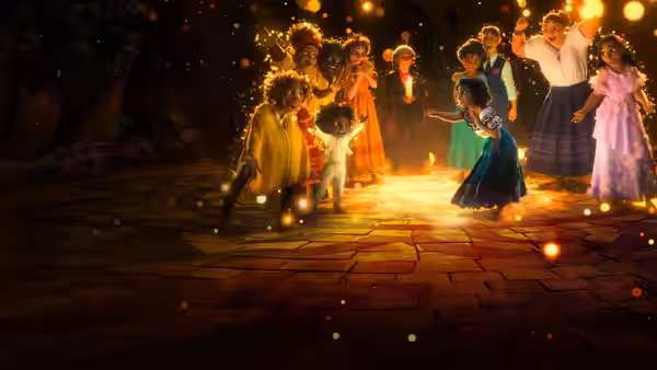 Family dancing together on a brick patio with floating lights
