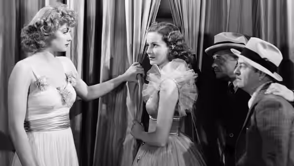 A blonde woman holds back a curtain while a dark-haired woman looks toward two men
