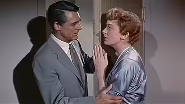 Nickie Ferrante (Cary Grant) holds Terry McKay (Deborah Kerr) close beside a doorway