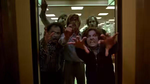 Zombies reach forward through an open doorway with outstretched hands