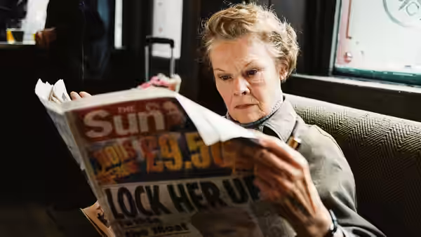 Barbara Covett (Judi Dench) reads a newspaper on public transport