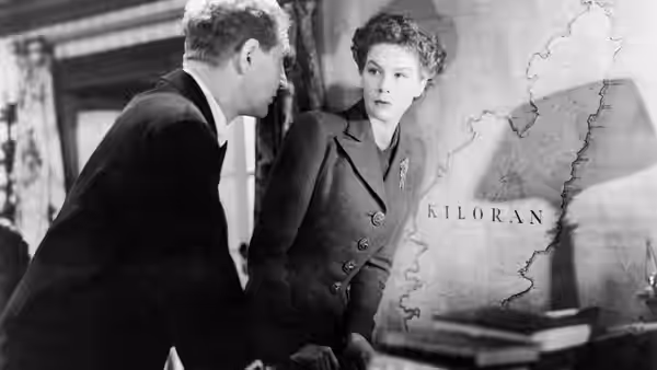 Joan Webster (Wendy Hiller) and Torquil MacNeil (Roger Livesey) consult a map of Kiloran