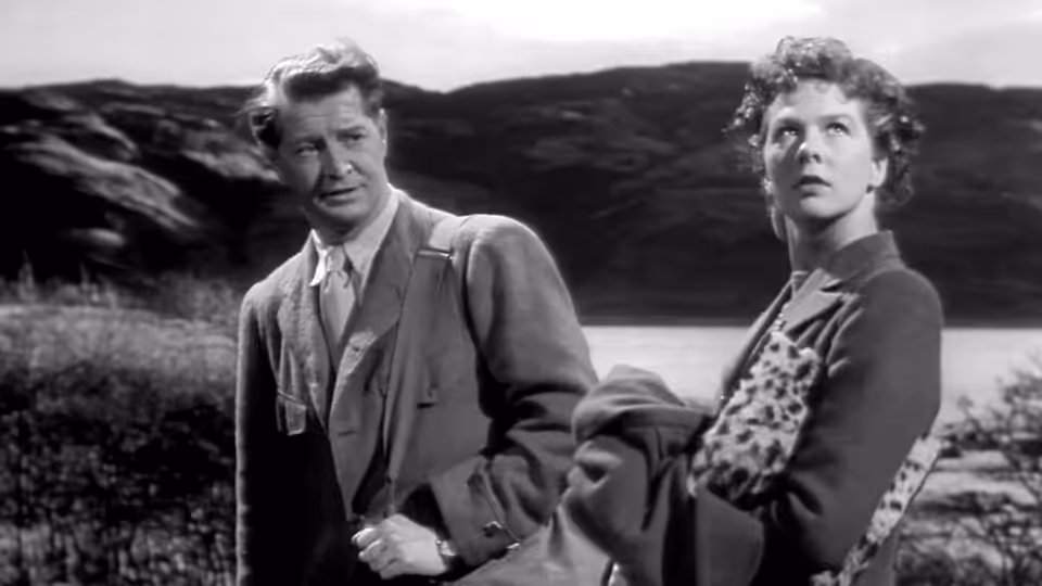 Joan Webster (Wendy Hiller) and Torquil MacNeil (Roger Livesey) stand beside a loch