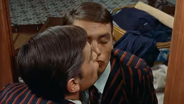 Tom Ripley (Alain Delon) studies his reflection in a striped jacket