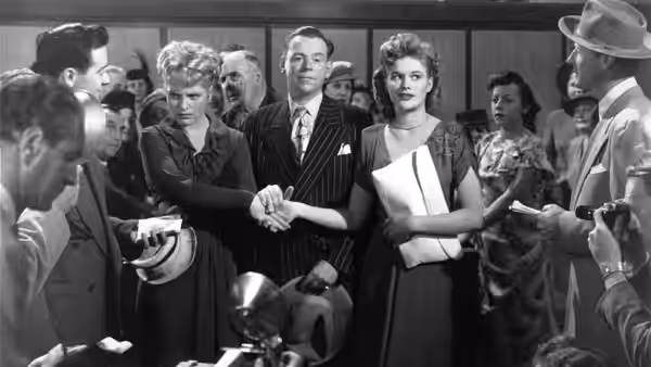 Adam Bonner (Spencer Tracy) and Amanda Bonner (Katharine Hepburn) face reporters outside the courthouse