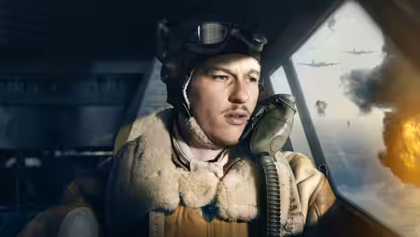 Buck Cleven (Austin Butler) in a flight helmet watches aircraft from a bomber cockpit