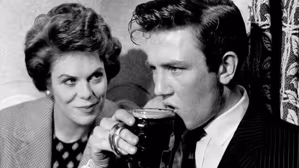 Arthur Seaton holds a cup as Brenda smiles beside him