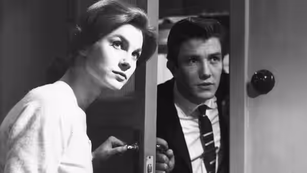 Arthur Seaton and Doreen peer through a doorway