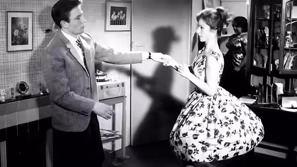 Arthur Seaton takes Doreen's hand in a café