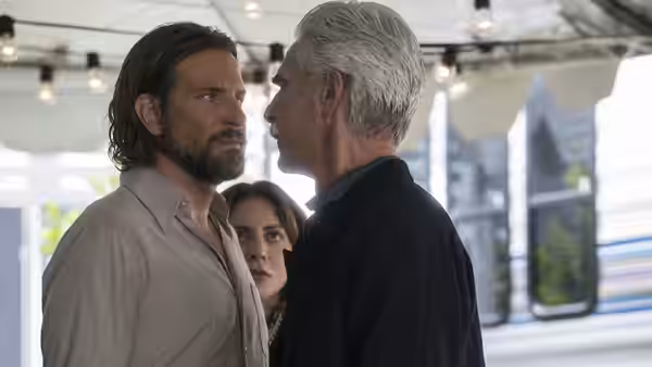 Bobby Maine (Sam Elliott) faces Jackson Maine (Bradley Cooper) as Ally (Lady Gaga) watches