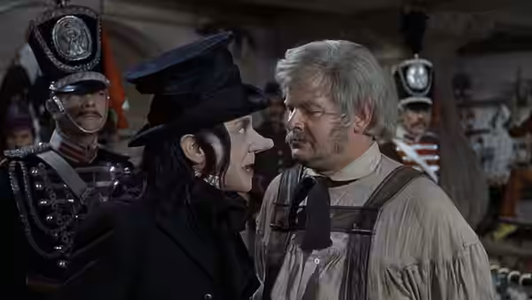 Man in black hat facing another man closely in a crowded hall