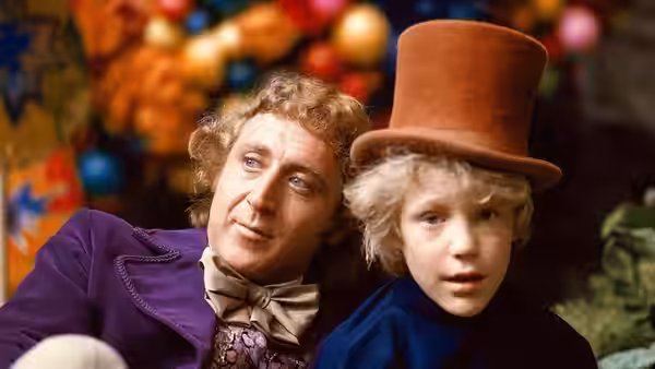 Willy Wonka (Gene Wilder) and Charlie (Peter Ostrum) sit together