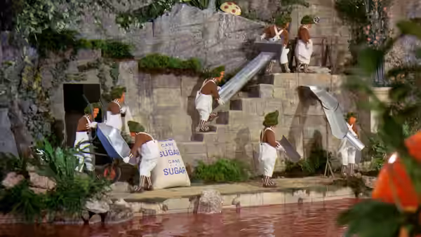 Oompa Loompas work on stairs and machinery by the river