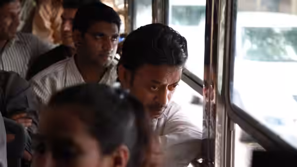 Saajan Fernandes (Irrfan Khan) leans toward the open window of a crowded train
