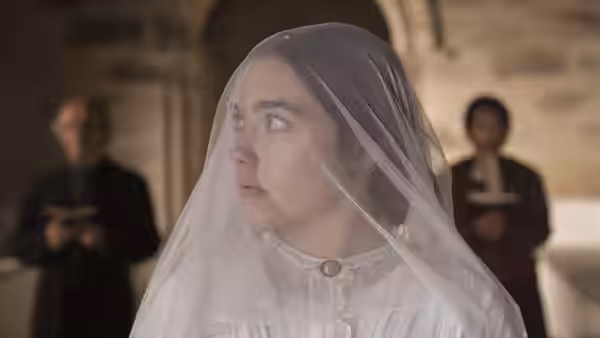 Katherine Lester (Florence Pugh) wears a bridal veil during a church ceremony