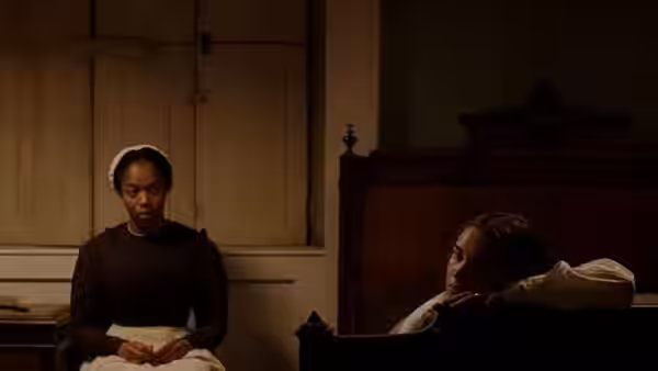 Anna (Naomi Ackie) sits beside Katherine Lester (Florence Pugh), who reclines in a chair