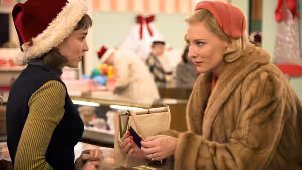 Therese Belivet (Rooney Mara) and Carol Aird (Cate Blanchett) facing each other in a department store